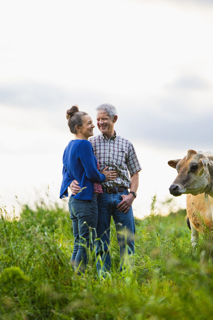 MOFGA-certified organic farmers Sonja Heyck-Merlin and Steve Morrison standing in a pasture.